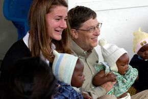 Melinda and Bill Gates holding babies at Mozambique’s Manhica Health Research Center, a beneficiary of a malaria research project grant from the Bill and Melinda Gates Foundation