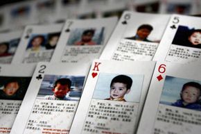 These playing cards show pictures of children kidnapped in China by traffickers.