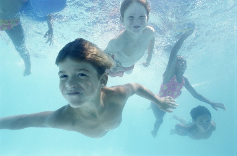 Children swim underwater.
