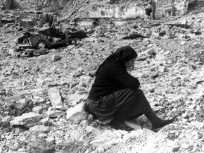A woman sits amid the rubble of what was once the village of Longarone, below the Vaiont Dam in Italy.