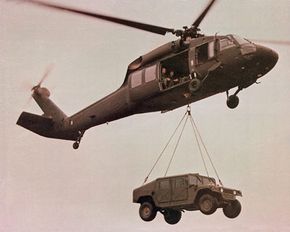 Helicopter airlifting a Humvee