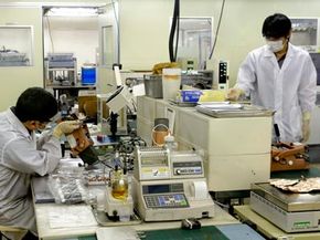 Nissan Motors researchers study electric car battery technology at the automaker's laboratory in Yokosuka, near Tokyo, Japan. With many drivers uncertain about hybrid car battery packs, researchers are looking for ways to improve the technology.