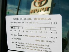 Hybrid cars, when using the gas engine, create pollution like any other conventional vehicle. The use of an electric motor, however, cuts down on that pollution. Above, a smog emissions sticker is on the window of a gasoline-electric hybrid Toyota Prius.