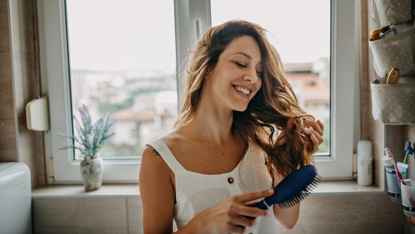 A young woman combing her hair