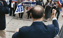 man with male pattern baldness giving political speech