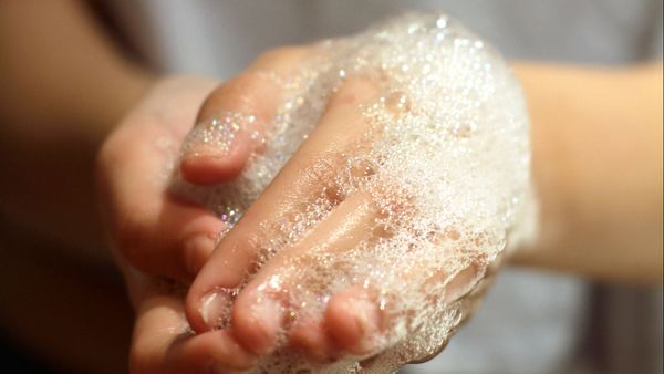 Close-up of wet woman's hand.