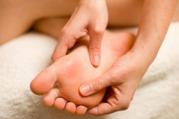 A woman massaging her foot.