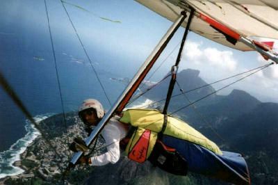 Person soaring through outdoors on extreme adventure with parachute.