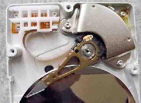 The arm and motor on an exposed hard disk drive.