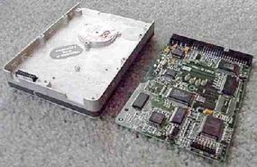 Two internal halves of a hard disk drive, showing the board.