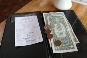 Restaurant check with cash in folder