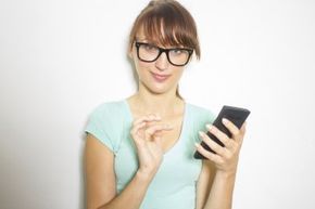Bespectacled woman with calculator