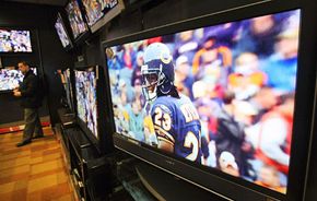 HDTV Image Gallery A shopper inspects HDTVs in a store in New York City. See more HDTV pictures.