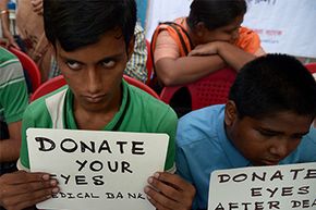 Visually challenged youth in India hold posters during a campaign to create awareness about eye donation in Kolkata on Aug. 27, 2014.