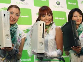 Models show, from left, the Xbox 360 Arcade, the new 60-gigabyte Xbox 360 and the Xbox Elite during a Microsoft press conference in Tokyo Monday, Sept. 1, 2008.