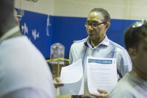 A volunteer with AARP and the Legal Counsel for the Elderly hands out literature about Obamacare and Medicare in Washington, DC.