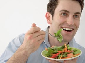 A man eats a salad.