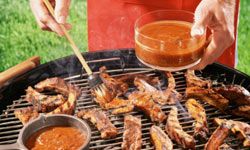 Pork chops being marinated on grill