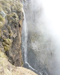 A cliffside with a waterfall.