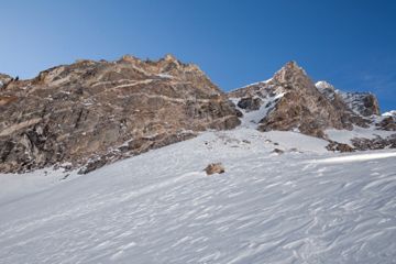 Snowy winter atop majestic mountain peak.