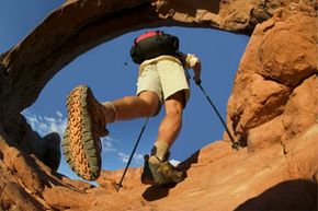 Person adventuring outdoors, hiking and mountain climbing.