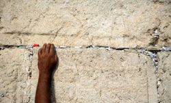 Some worshippers leave written prayers in the wall's cracks.