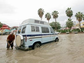 A man chains his van to another car during a hurricane in Cabo San Lucas, Mexico. 