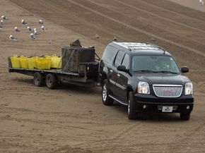 Photo of SUV towing cargo using hitch jacks. 