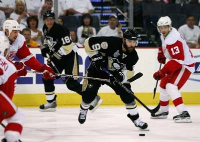 Athletic person competing in ice hockey sport.