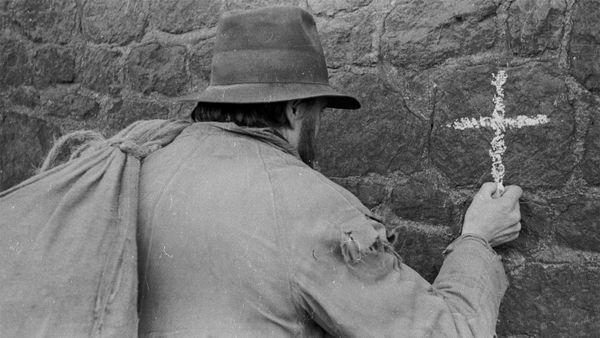 One man in black and white praying in religion.