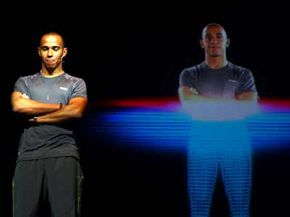 Formula 1 driver Lewis Hamilton of Great Britain stands next to a 3D hologram during the Reebok launch of their new Smooth Fit technology.