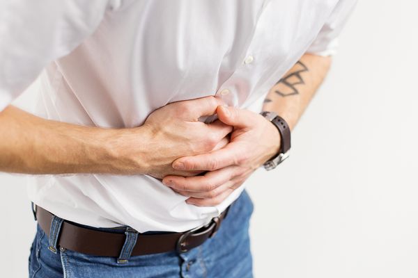 Man holding his stomach in pain