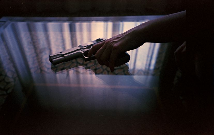 Spy thriller book cover design with man holding pistol gun.