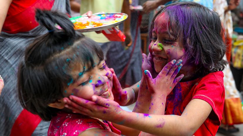 Girls smear each other with abir