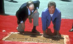 Mel Gibson pressing his hands into the wet cement at the Walk of Fame