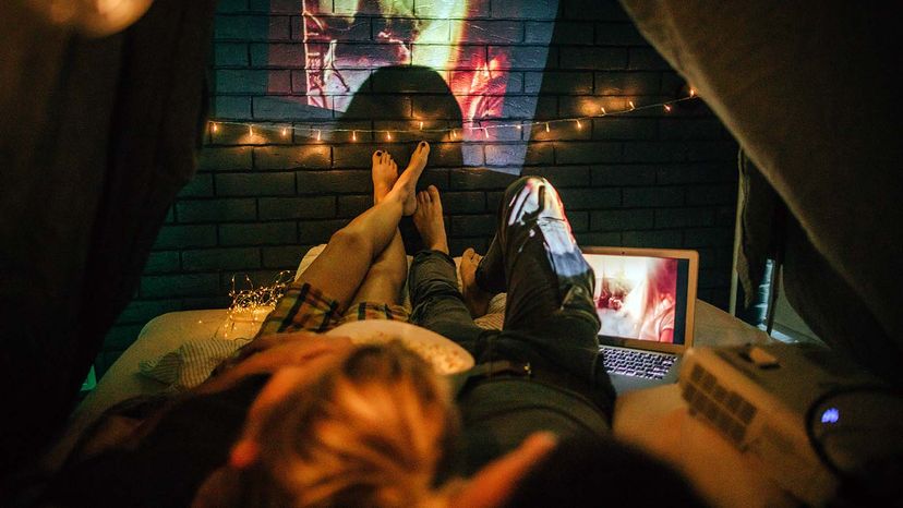 Romantic couple watching movies in home theater