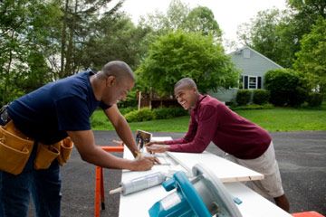 Father and son working on home remodeling project.