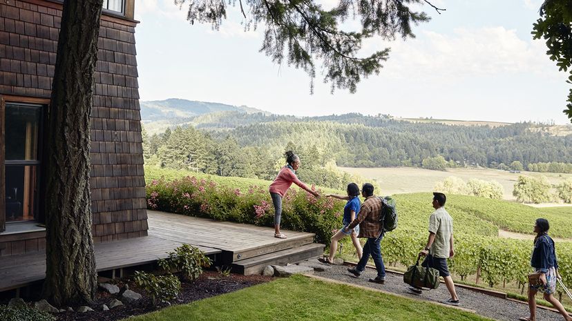 An Airbnb host greets guests at her home in Oregon. Airbnb