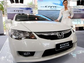 Models present the new Honda Civic Hybrid car at its launch in Kuala Lumpur, Malaysia, on March 19, 2009.