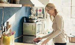 Woman cleaning kitchen. 