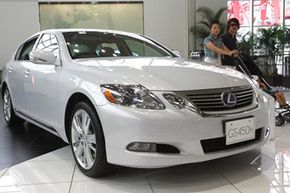 Visitors look at the Toyota Lexus GS 450h at a Toyota showroom in Tokyo, on July 1, 2010.