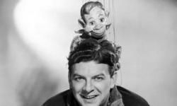 Promotional studio portrait of 'Buffalo' Bob Smith with Howdy Doody on his shoulders.
