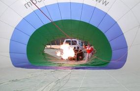 The burner flame blowing hot air into the balloon.