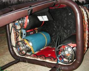 A hot air balloon basket containing three propane tanks.