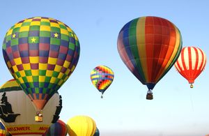 Hot air balloons fly.