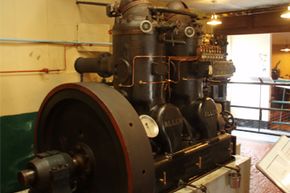 A 2-cylinder, 70 horsepower hot bulb engine built by W.H. Allen & Sons in 1923. The engine is on display at the Internal Fire Museum of Power, Tangygroes, Wales, UK.”border=