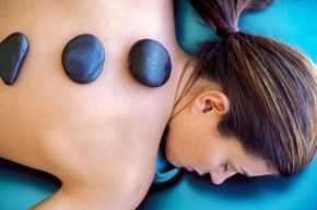 Hot stone therapy can increase joint flexibility, among other benefits.