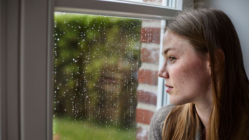 woman looking out of window