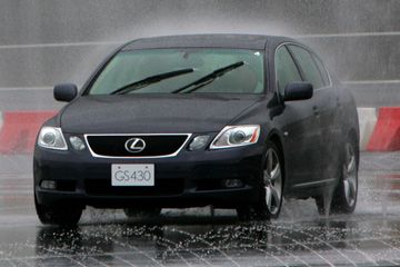 A Lexus GS is driven to demonstrate its VGRS safety system as part of a demonstration of safety features at Toyota's test course at Fuji Speedway, west of Tokyo.