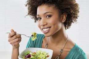 lady smiling eating salad